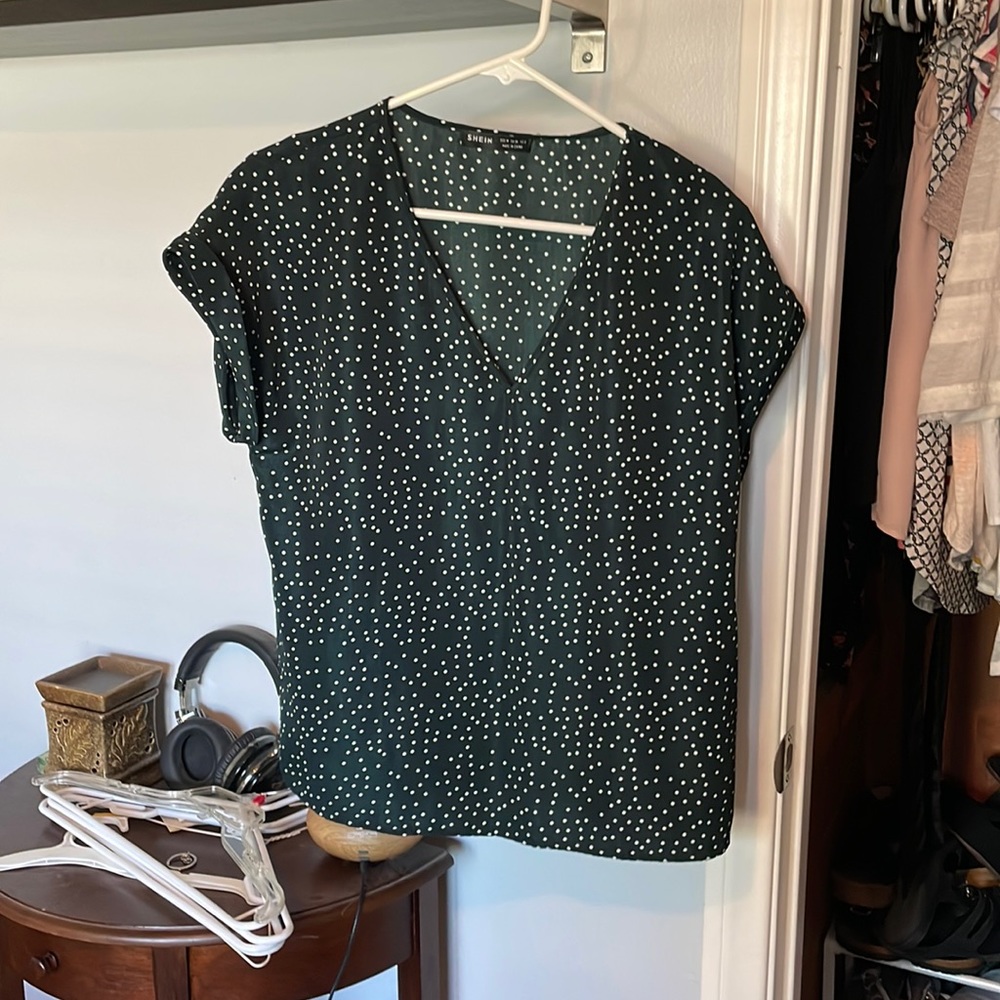 Navy blue blouse with white polka dots.